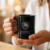 Leaders of Healthcare Black Coffee Mug — Lion Crest Logo Ceramic 11oz/15oz